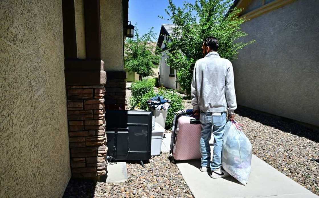 A man and his family gather their belongings after being evicted from a residential property A man and his family gather their belongings after being evicted from a residential property