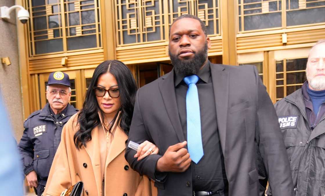Jen Shah in a Caramel coloured coat being held as she left Manhattan federal court Jen Shah in a Caramel coloured coat being held as she left Manhattan federal court