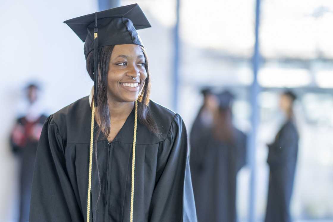 A female University student smiling on graduation day A female University student smiling on graduation day