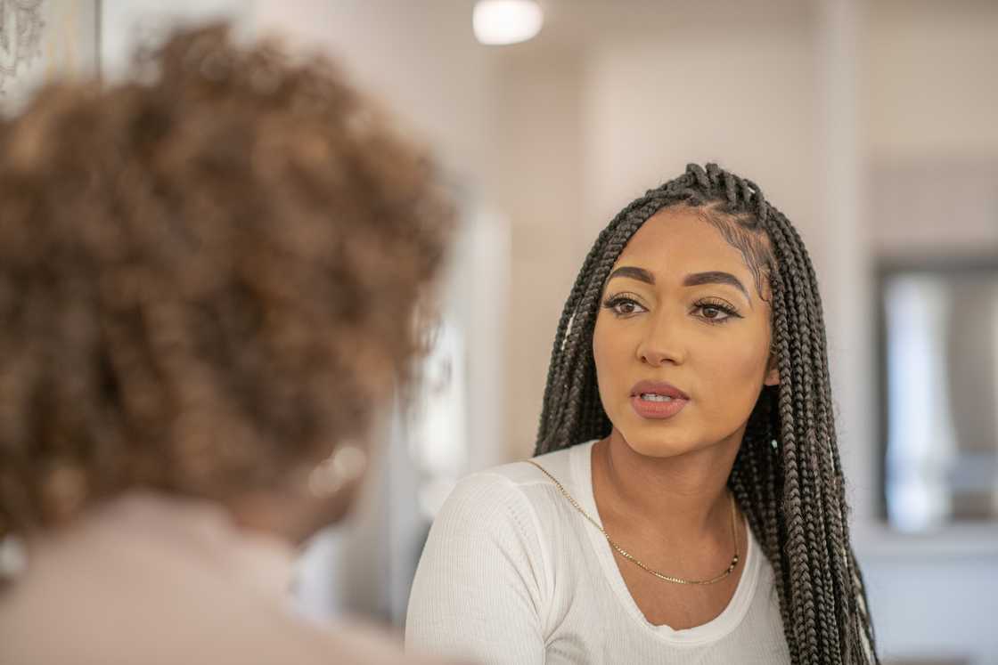 A woman talking to her friend at home. A woman talking to her friend at home.
