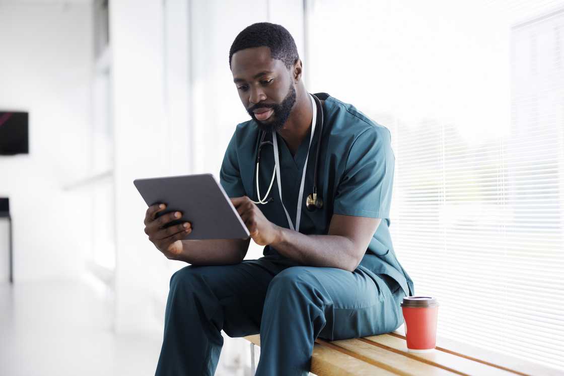 A doctor sitting on a hallway A doctor sitting on a hallway