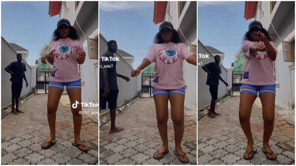 Lady danced in compound/gateman watched her.