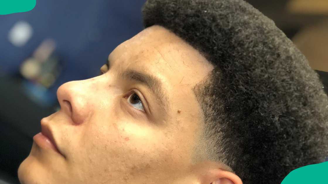 A man with a short afro with temple fade hairstyle A man with a short afro with temple fade hairstyle