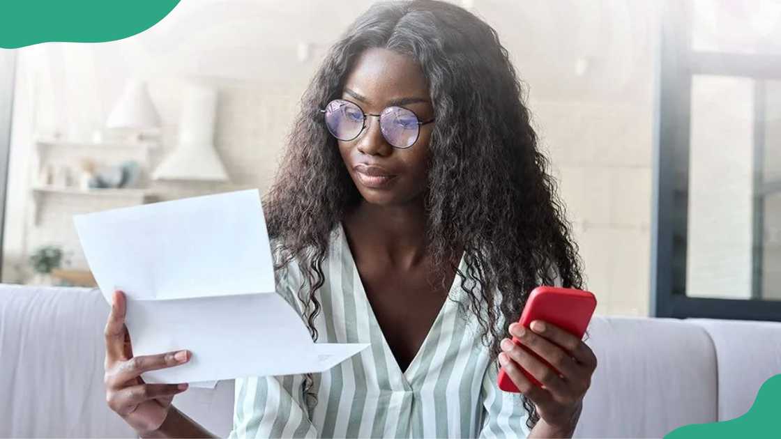 A young woman reading a document.
