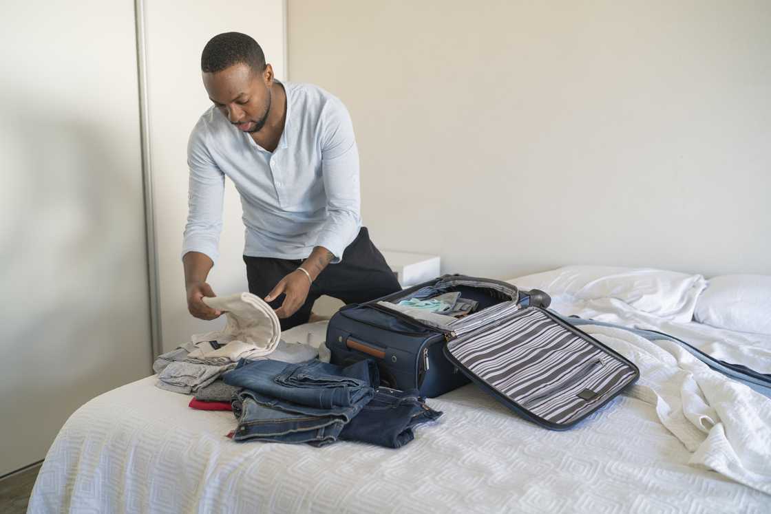 A man packs his clothes