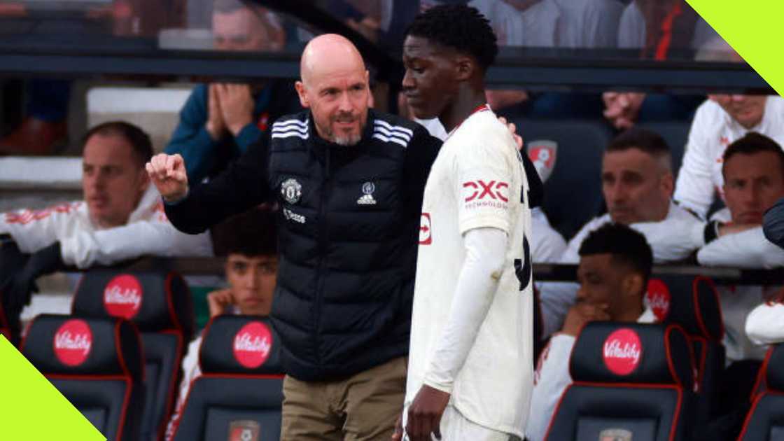 Kobbie Mainoo receives instructions from Erik ten Hag.