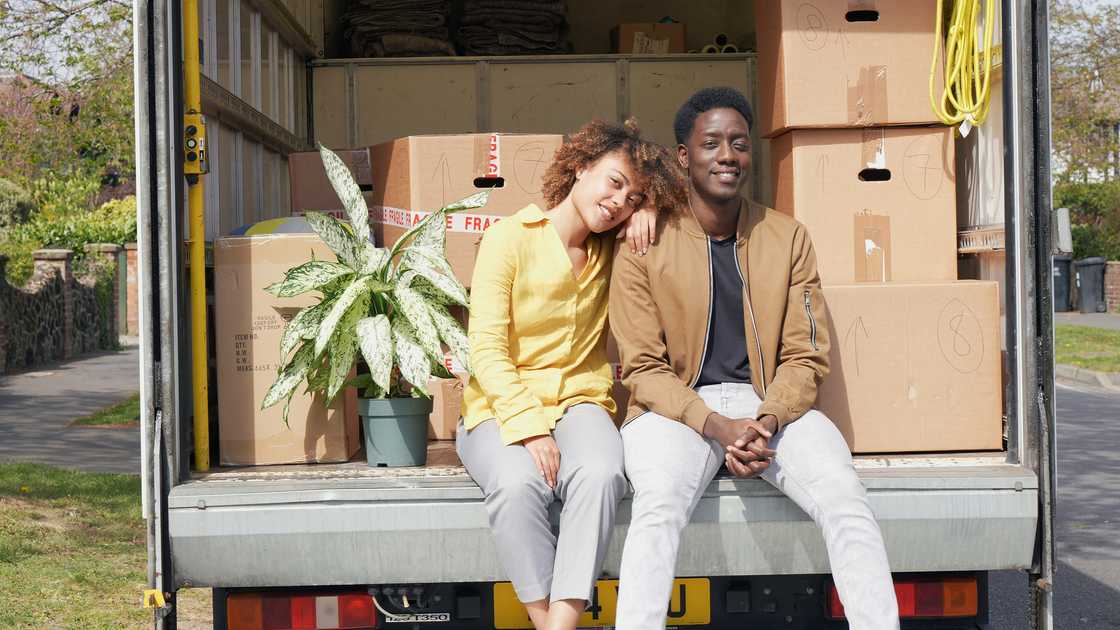 A couple seated at the back of a truck