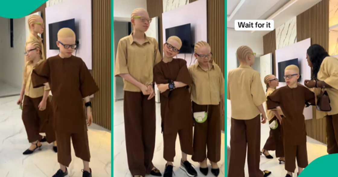 Nigerian mother shows off her three children who have albinism.