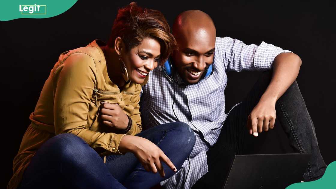 A couple watching a movie on a laptop A couple watching a movie on a laptop
