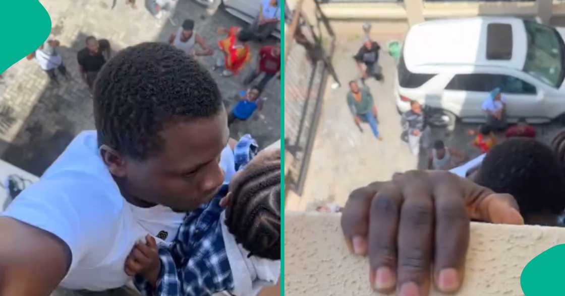 Moment man holds on to baby while hanging from balcony of building on fire Moment man holds on to baby while hanging from balcony of building on fire