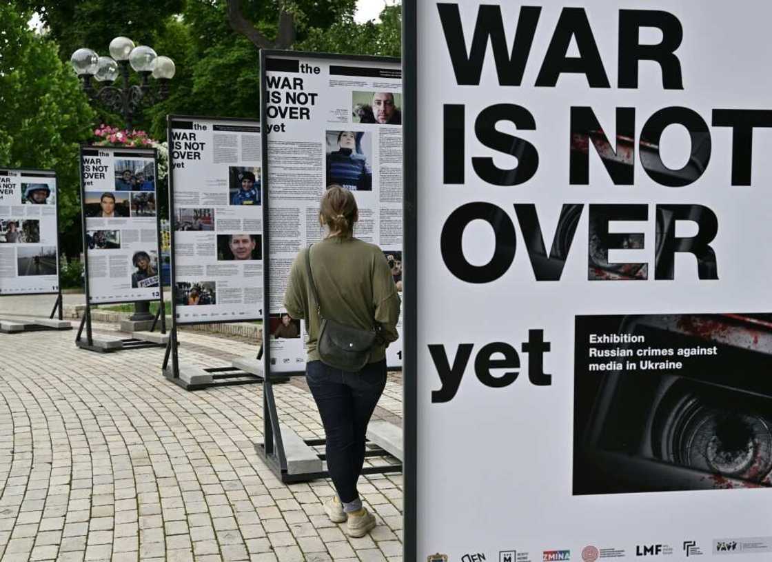 Portraits of reporters and media workers who have become victims of the conflict stare down at passersby from large black and white boards in the capital's centre Portraits of reporters and media workers who have become victims of the conflict stare down at passersby from large black and white boards in the capital's centre