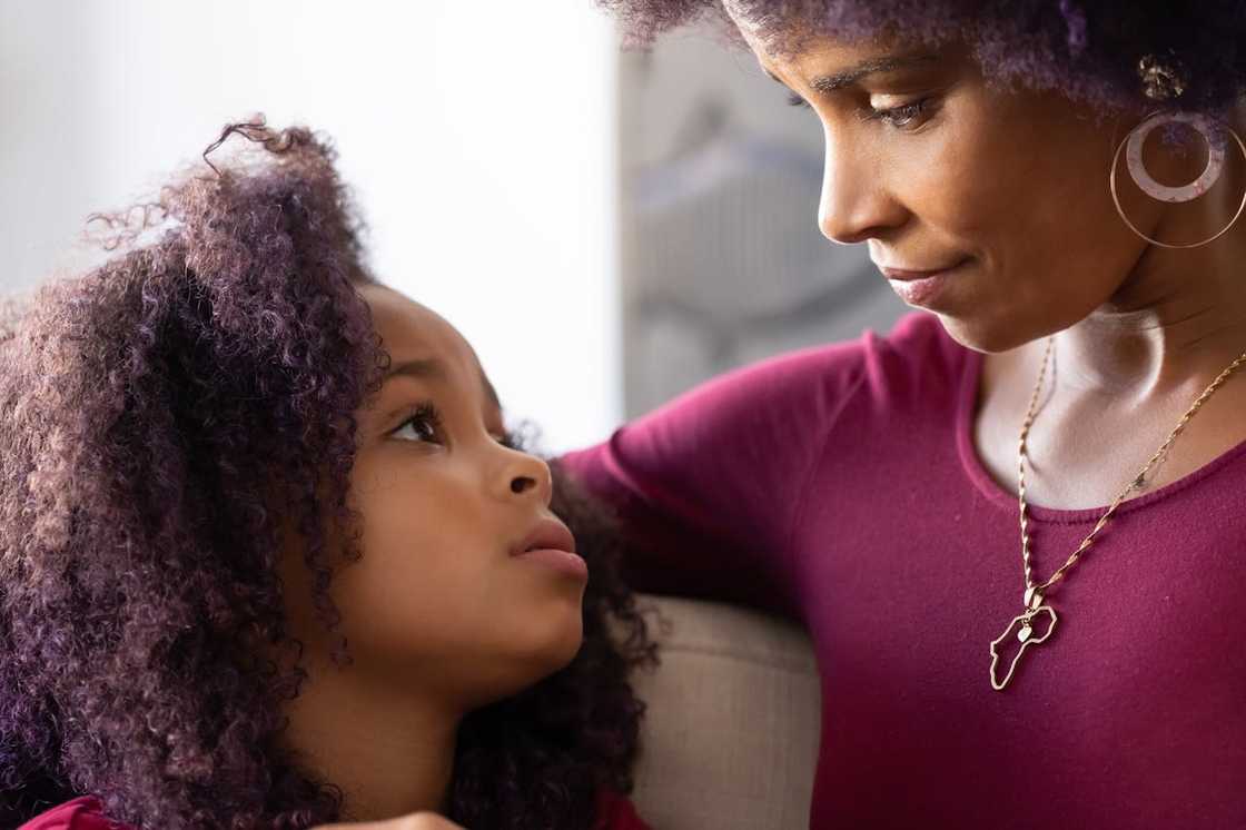 Mother and daughter sharing a quiet emotional moment. Mother and daughter sharing a quiet emotional moment.