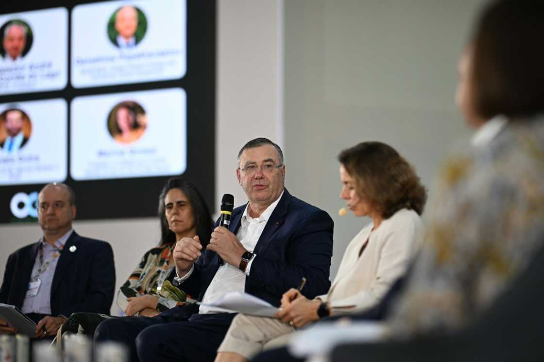 TotalEnergies chief executive Patrick Pouyanne (C) defended his presence at the UN climate talks in the Brazilian Amazon when confronted by a Greenpeace activist about the attendance of fossil fuel lobbyists, insisting 'I believe in dialogue' TotalEnergies chief executive Patrick Pouyanne (C) defended his presence at the UN climate talks in the Brazilian Amazon when confronted by a Greenpeace activist about the attendance of fossil fuel lobbyists, insisting 'I believe in dialogue'