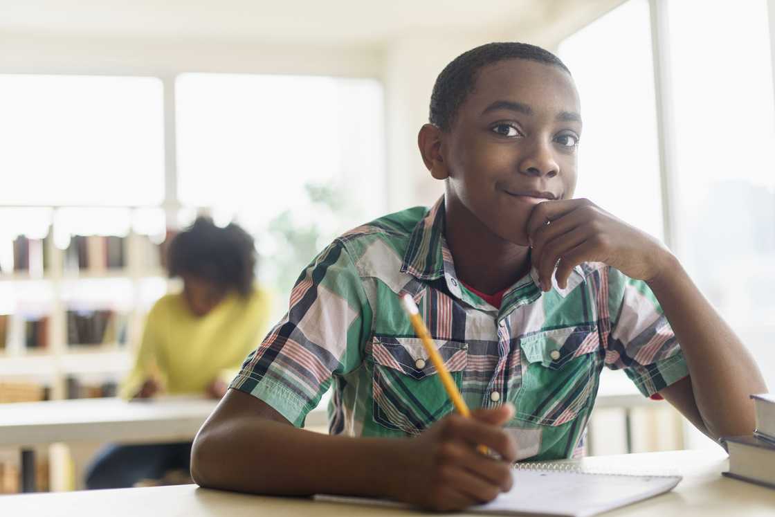 Black student thinking in classroom Black student thinking in classroom