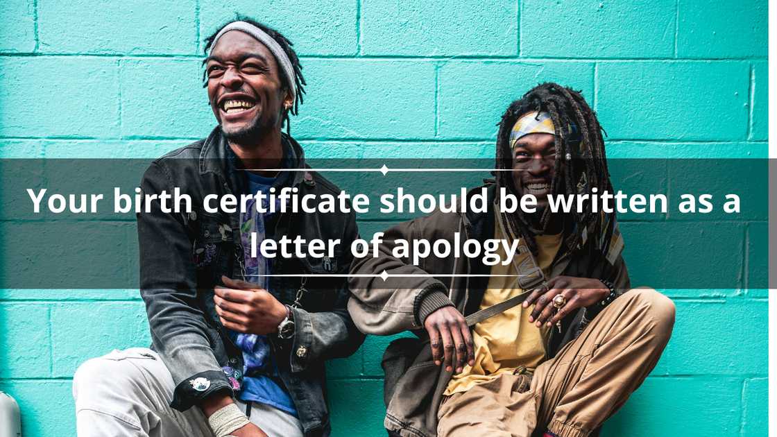 Two guys sitting and leaning against a blue wall in laughing Two guys sitting and leaning against a blue wall in laughing