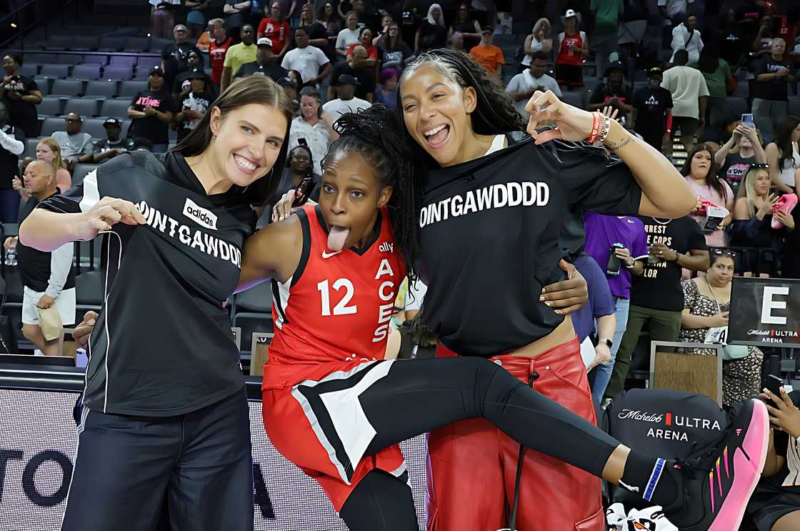 Anna Petrakova, Chelsea Gray, and Candace Parker pose on the court