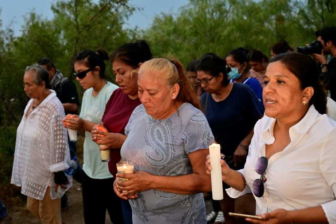 Friends and relatives hold a candlelit vigil for the trapped miners