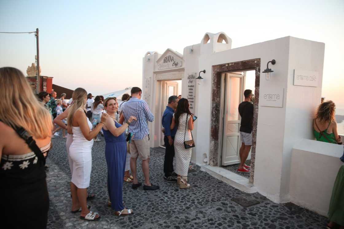 Tourists queue as they wait to take a picture from one of the balconies