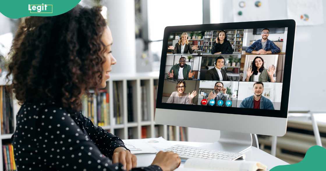 A woman smiles at other participants in a Zoom call.