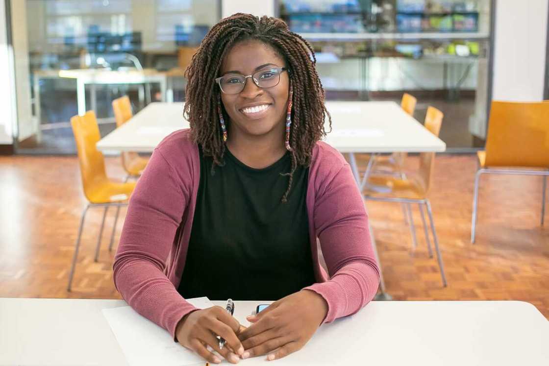 A woman in glasses sitting in class