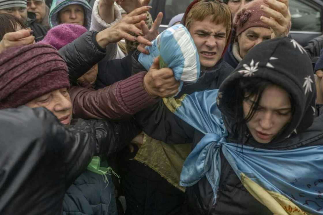 Shouting matches and shoving erupted as volunteers tossed supplies into crowds Shouting matches and shoving erupted as volunteers tossed supplies into crowds
