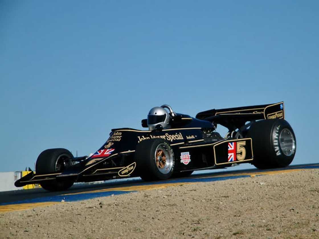 A driver racing in a black Lotus 78