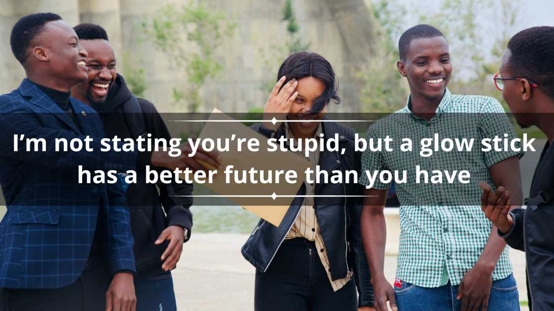 A group of five people made of four men and one woman laughing at something one of them is saying A group of five people made of four men and one woman laughing at something one of them is saying