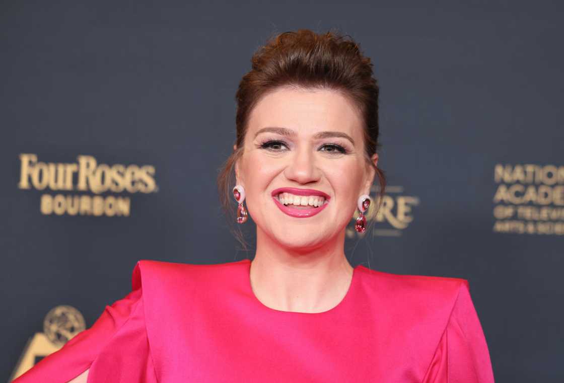 Close-up of Kelly Clarkson with her hair pinned up, smiling in a hot-pink dress at the 51st Daytime Emmy Awards in Los Angeles, 2024