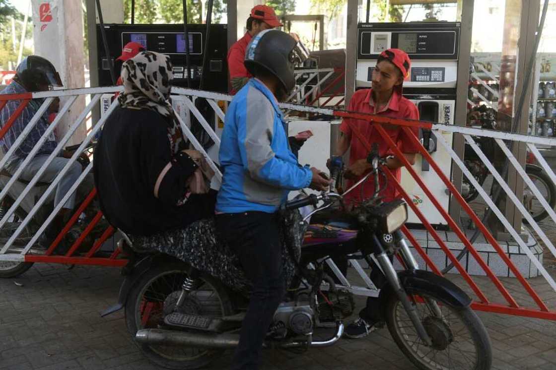An employee of a petrol station fills a motorbike's tank in Karachi in February 2023 after a hike in prices by the government An employee of a petrol station fills a motorbike's tank in Karachi in February 2023 after a hike in prices by the government