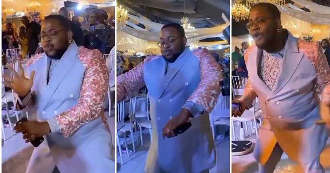 Pot bellied man dances Buga, wedding guest