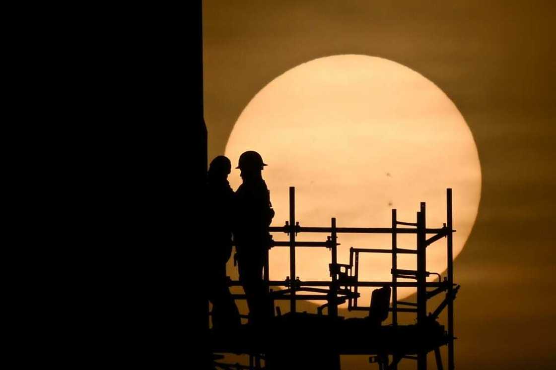 Workers prepare Starship for its first test flight from the SpaceX spaceport in Boca Chica, Texas