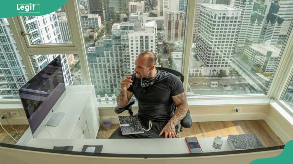 Wes Watson in his office with a cityscape view Wes Watson in his office with a cityscape view