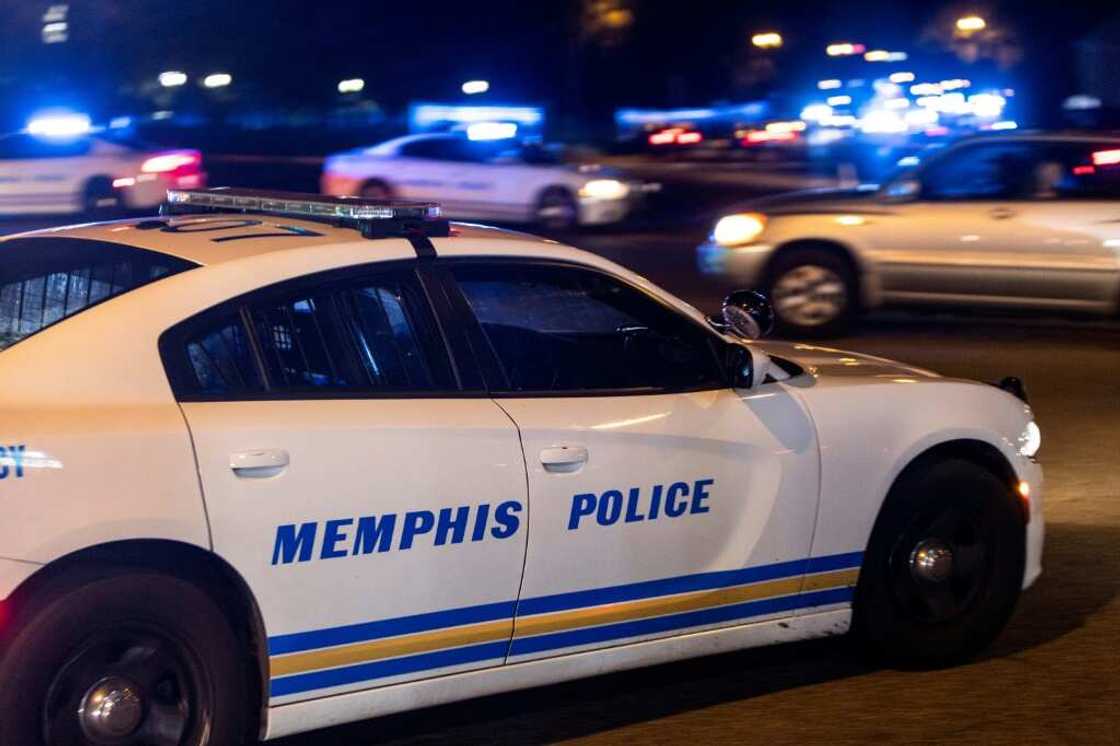 Police investigate the scene of a carjacking related to the Memphis shooting spree