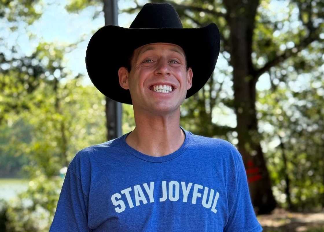 Tanner Smith poses in a blue t-shirt and a black cowboy hat. Tanner Smith poses in a blue t-shirt and a black cowboy hat.