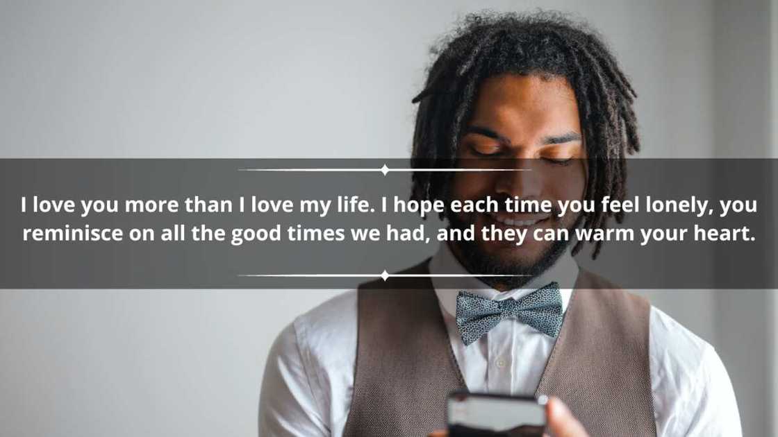 A young man in deadlocks, a white shirt, and a brown-waistcoat is texting A young man in deadlocks, a white shirt, and a brown-waistcoat is texting