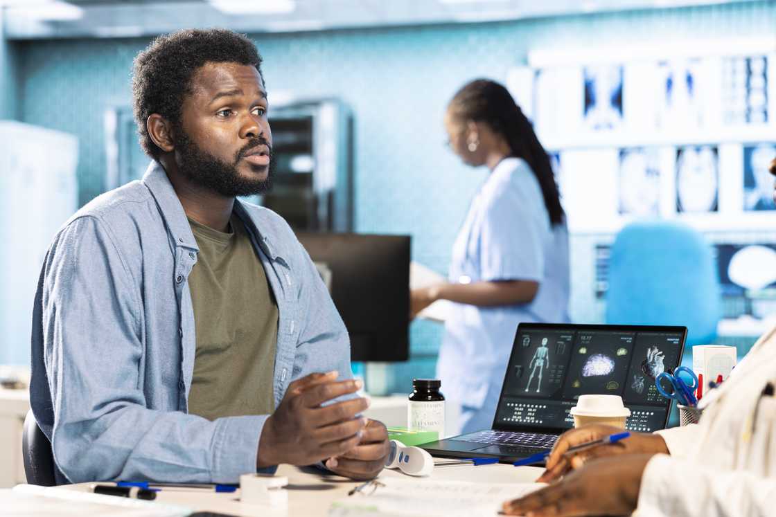Man in formal shirt speaking to laboratory technician. Man in formal shirt speaking to laboratory technician.