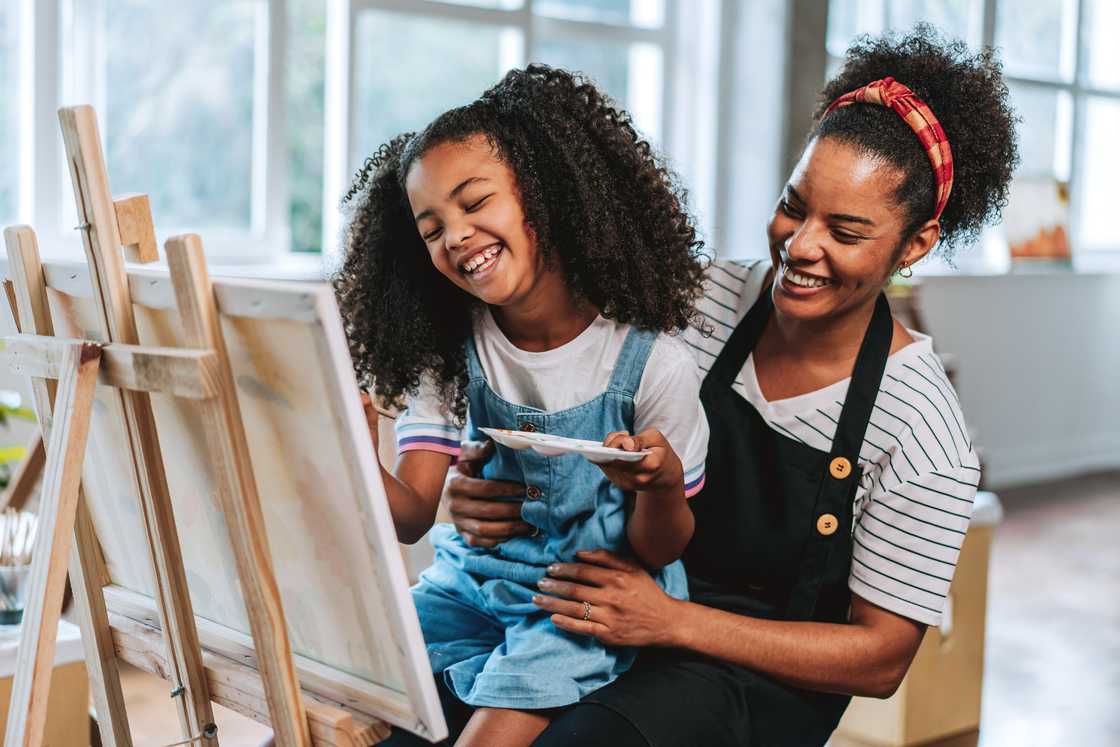 A mom and daughter painting A mom and daughter painting