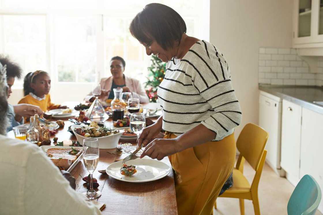 Friends enjoying appetizers on the dining table at home