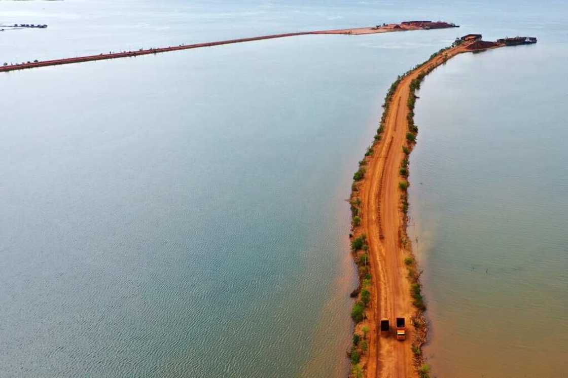 Trucks transport soil containing nickel ore in Pomalaa in southeast Sulawesi Trucks transport soil containing nickel ore in Pomalaa in southeast Sulawesi