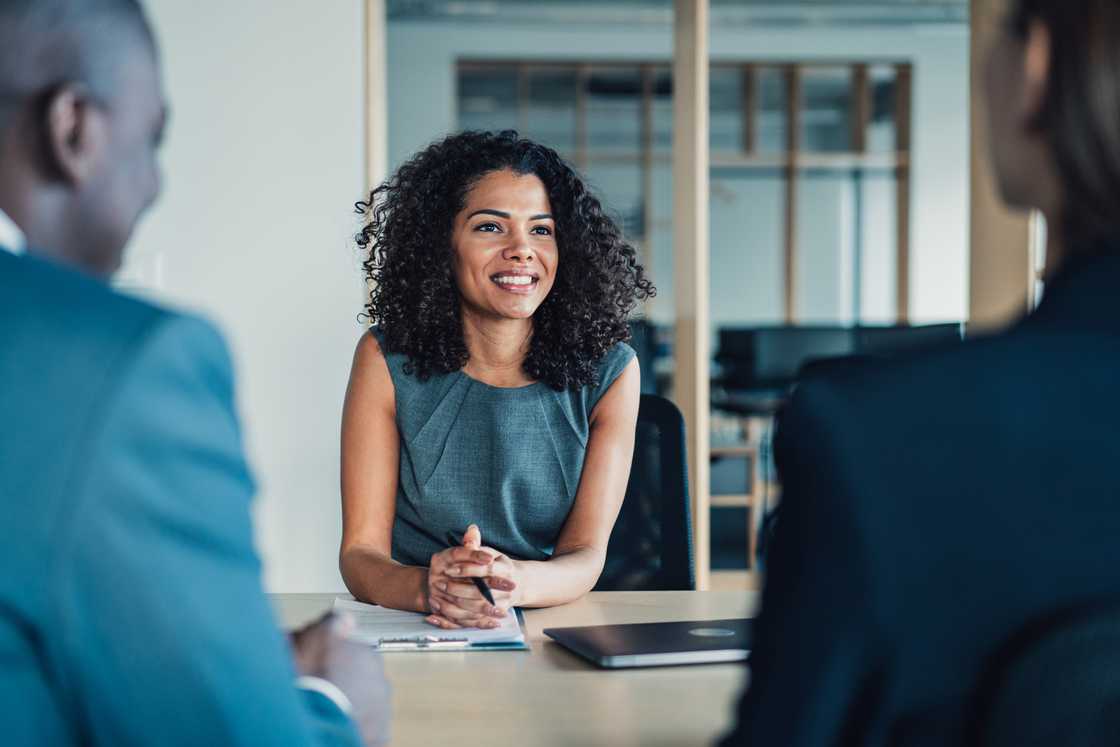 A woman candidate during an interview in a corporate boardroom.
