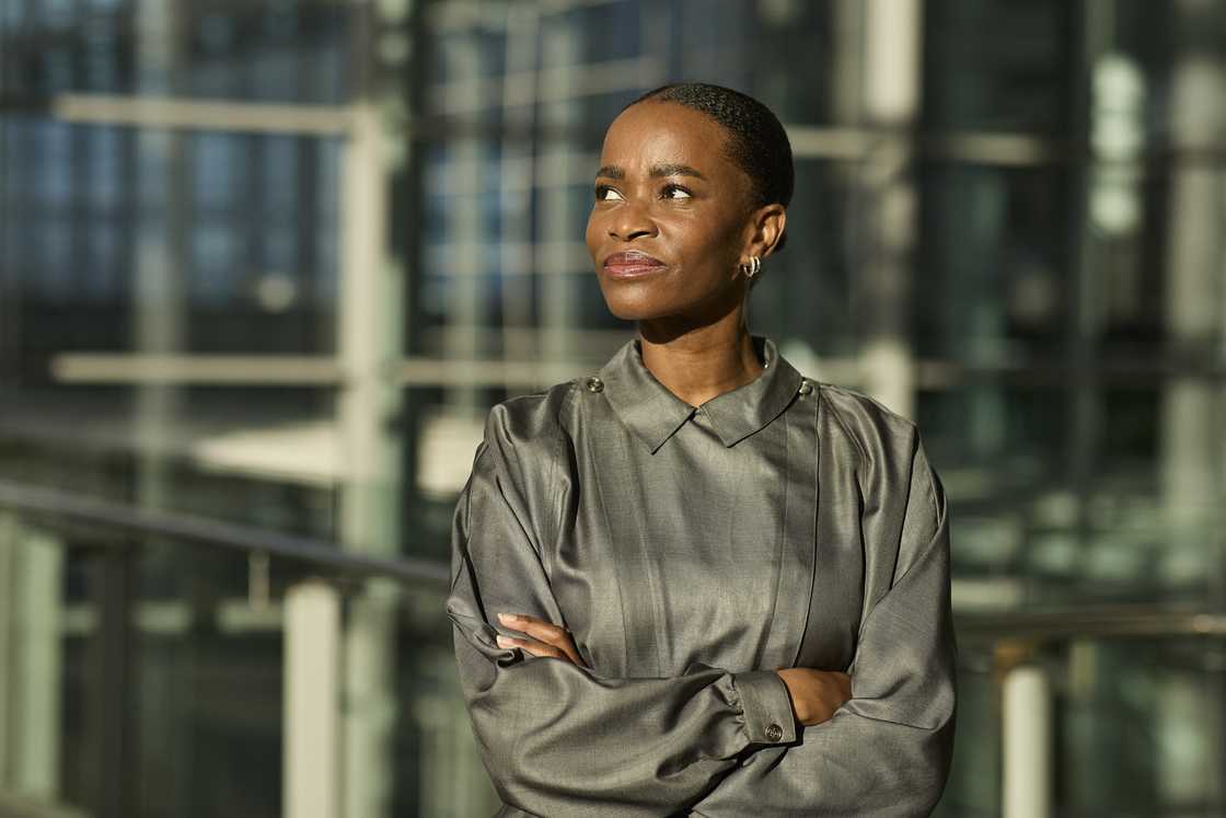 A thoughtful woman with arms crossed A thoughtful woman with arms crossed