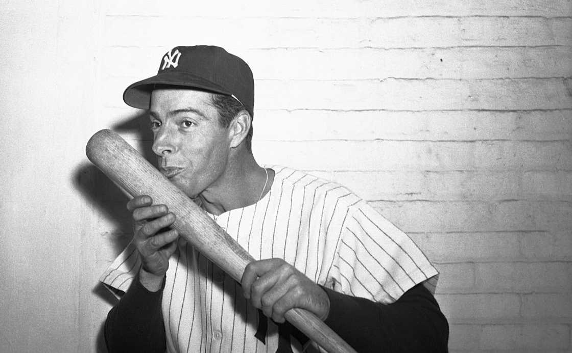 Joe DiMaggio poses with a bat Joe DiMaggio poses with a bat