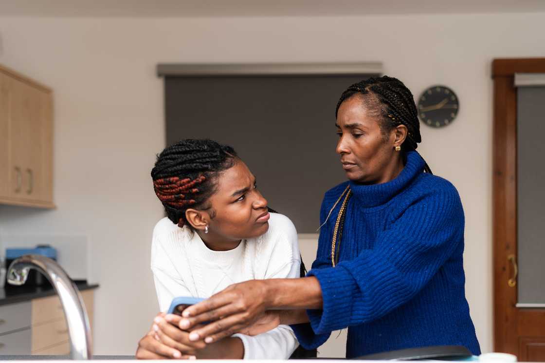 A mother confiscating daughter’s phone.