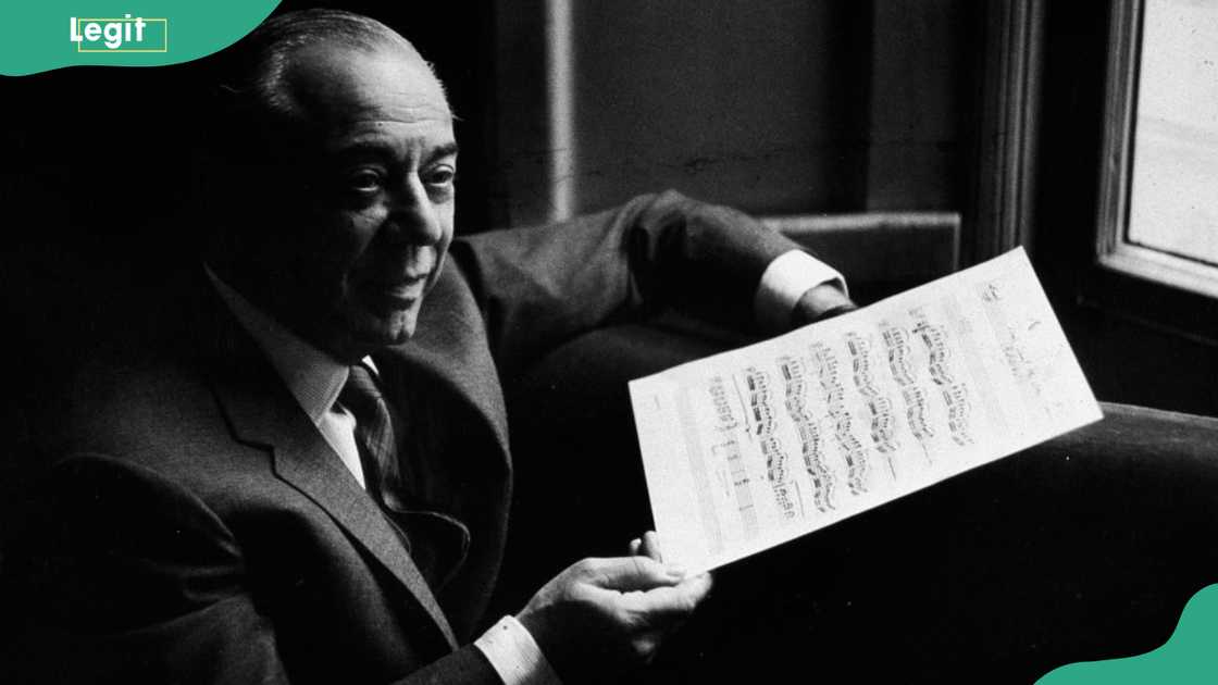 American composer Richard Rodgers (1902 - 1979) smiles and holds a musical score while in rehearsal for the musical, 'The Boys From Syracuse.