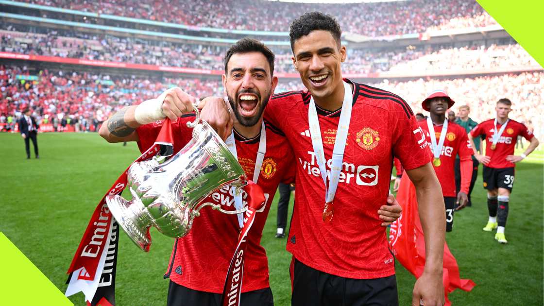 Raphael Varane and Bruno Fernandes celebrate FA CUP success. Raphael Varane and Bruno Fernandes celebrate FA CUP success.