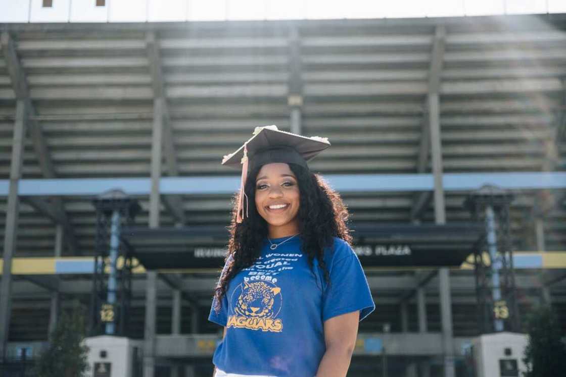 Young lady wearing a blue shirt with a graduation gown Young lady wearing a blue shirt with a graduation gown