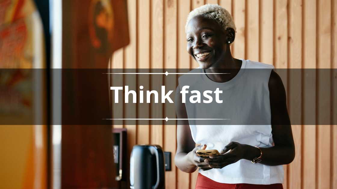 A woman in a white sleeveless top smiles as she uses a smartphone A woman in a white sleeveless top smiles as she uses a smartphone