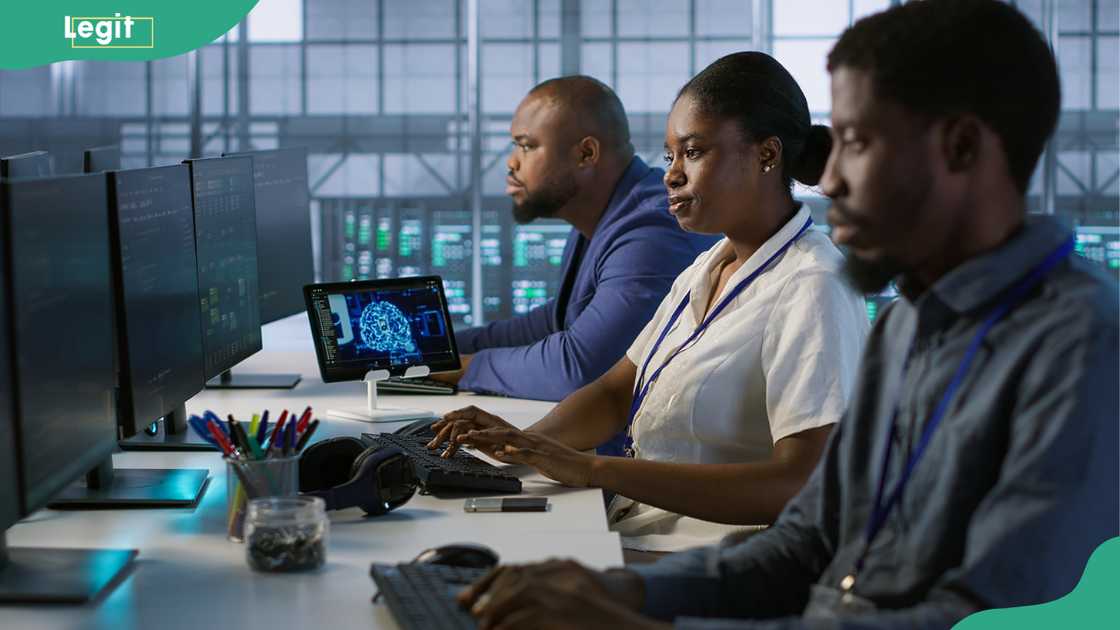 Technicians using computers and tablet in data center Technicians using computers and tablet in data center