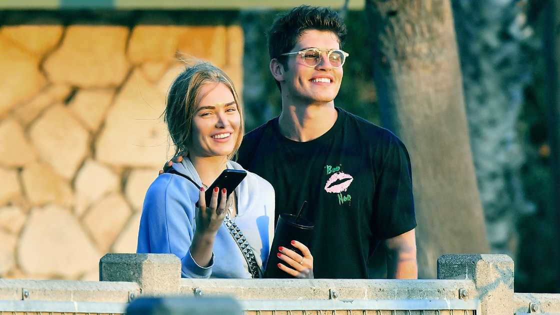 Michelle Randolph and her former boyfriend Gregg Sulkin hold each other during a casual stroll on the beach
