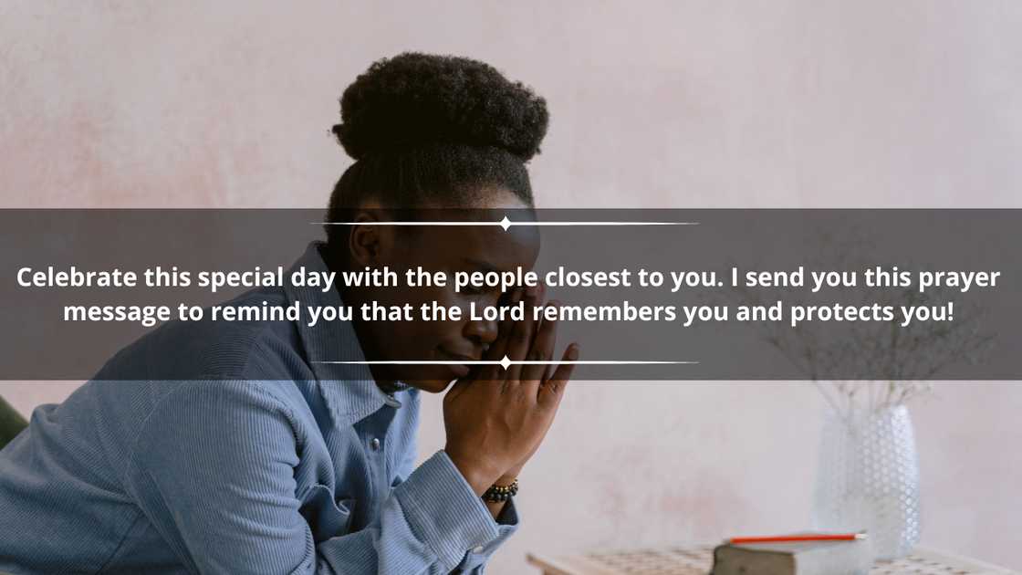 A woman in a blue dress shirt is praying